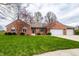 Beautiful brick house featuring a well-maintained lawn and an attached two car garage at 1550 Renee Dr, Plainfield, IN 46168