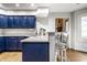 Kitchen with blue cabinets, stainless steel appliances, and a bar at 1550 Renee Dr, Plainfield, IN 46168