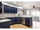 Modern kitchen with hardwood floors, dark blue cabinets, and stainless-steel appliances at 1550 Renee Dr, Plainfield, IN 46168