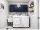 Laundry room featuring modern appliances, cabinetry, utility sink, and shelving at 1550 Renee Dr, Plainfield, IN 46168