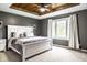 Primary bedroom featuring a large bed, tray ceiling, and light gray carpet at 1550 Renee Dr, Plainfield, IN 46168