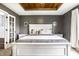 Comfortable main bedroom featuring a stylish wood tray ceiling and an ensuite bathroom at 1550 Renee Dr, Plainfield, IN 46168