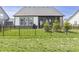 Spacious fenced backyard with lush green grass, mature evergreen trees, and a screened-in porch at 15755 Scher Dr, Westfield, IN 46074