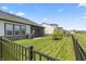 Well-manicured backyard featuring a spacious lawn, black fencing, and access to a screened-in porch perfect for outdoor enjoyment at 15755 Scher Dr, Westfield, IN 46074
