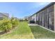 Well-maintained backyard with a screened-in porch, patio, lush lawn, and privacy landscaping at 15755 Scher Dr, Westfield, IN 46074