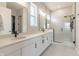 Modern bathroom showcasing a double sink vanity, decorative mirrors, and a glass-enclosed shower with a rain shower head at 15755 Scher Dr, Westfield, IN 46074