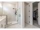 Bright bathroom with glass shower, white tile, and a view into the walk-in closet at 15755 Scher Dr, Westfield, IN 46074