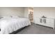 Bright bedroom with a large bed, white dresser, gray carpet, and an open doorway looking into the bathroom at 15755 Scher Dr, Westfield, IN 46074