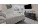 Cozy bedroom with large window, TV, dresser, and stylish accents and neutral decor at 15755 Scher Dr, Westfield, IN 46074
