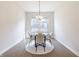 Bright dining room with contemporary chandelier, round table, and four elegant chairs at 15755 Scher Dr, Westfield, IN 46074