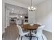 Open-concept dining room with elegant light fixture and views of the kitchen and living room at 15755 Scher Dr, Westfield, IN 46074