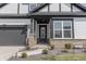 Welcoming home with a decorated front door, brick accents, manicured landscaping, and stone walkway at 15755 Scher Dr, Westfield, IN 46074
