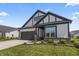 Charming home featuring gray and white colors, complemented by a landscaped front yard and a convenient two-car garage at 15755 Scher Dr, Westfield, IN 46074
