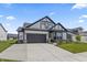 Charming home featuring gray and white colors, complemented by a landscaped front yard and a convenient two-car garage at 15755 Scher Dr, Westfield, IN 46074