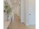 Bright hallway with wood floors and an accent tree and bench at 15755 Scher Dr, Westfield, IN 46074