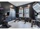 Modern home gym featuring a full weight rack, Peloton bike, and stylish black walls at 15755 Scher Dr, Westfield, IN 46074