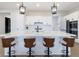 Kitchen island with bar seating, stainless steel sink, and sleek pendant lighting at 15755 Scher Dr, Westfield, IN 46074