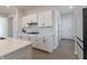 Modern kitchen with white cabinets, stylish hardware, quartz countertops and tiled backsplash at 15755 Scher Dr, Westfield, IN 46074