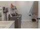 Well-equipped laundry room featuring a modern washer, dryer, sink, and pet amenities at 15755 Scher Dr, Westfield, IN 46074