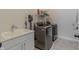 Convenient laundry room with modern washer and dryer, utility sink, and pet-friendly decor at 15755 Scher Dr, Westfield, IN 46074