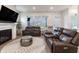 Well-lit living room showcases comfortable seating, fireplace, and backyard views from the large windows at 15755 Scher Dr, Westfield, IN 46074