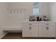 Well-organized mudroom area featuring white cabinets, hooks, and built-in bench at 15755 Scher Dr, Westfield, IN 46074