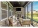 Cozy screened-in porch featuring a brick fireplace and comfortable seating at 15755 Scher Dr, Westfield, IN 46074