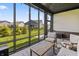 Relax in this covered porch with cozy furniture and outdoor views, perfect for enjoying the serene backyard at 15755 Scher Dr, Westfield, IN 46074