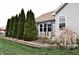 The backyard is well landscaped with a flower bed, evergreen trees, and a table with chairs at 1630 Valdarno Dr, Greenwood, IN 46143
