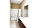 Well-lit bathroom featuring a combination shower and tub, toilet, vanity and sink with mirror at 1630 Valdarno Dr, Greenwood, IN 46143