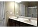 Bathroom with a double sink vanity, ample lighting, and a shower behind a glass door at 1630 Valdarno Dr, Greenwood, IN 46143