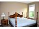 Spacious bedroom featuring a four-poster bed, window and matching nightstands at 1630 Valdarno Dr, Greenwood, IN 46143