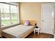Bedroom with wooden bed frame, neutral walls, window, and a small side table with lamps at 1630 Valdarno Dr, Greenwood, IN 46143
