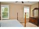 Bedroom with a four-poster bed, dresser and mirror, and two bright windows overlooking the exterior at 1630 Valdarno Dr, Greenwood, IN 46143