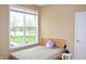 Bedroom with natural light, a full sized bed, white walls, and a large window with views of the outdoors at 1630 Valdarno Dr, Greenwood, IN 46143