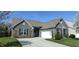 Charming single-Gathering home features a well-manicured lawn, a two-car garage, and blossoming trees in the front yard at 1630 Valdarno Dr, Greenwood, IN 46143