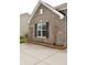 Exterior brick elevation with brick landscaping border with small flowers at 1630 Valdarno Dr, Greenwood, IN 46143
