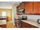 A kitchen view shows wood cabinets, granite countertops, and stainless steel appliances at 1630 Valdarno Dr, Greenwood, IN 46143