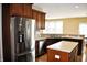 A kitchen view shows stainless steel refrigerator and sink with a center island at 1630 Valdarno Dr, Greenwood, IN 46143