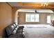 Bright living room offering archways, carpeting, fan, and an open concept to dining and kitchen at 1630 Valdarno Dr, Greenwood, IN 46143