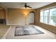 The sun-filled living room features a large window, neutral carpet, and a unique standing lamp at 1630 Valdarno Dr, Greenwood, IN 46143