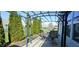 Cozy outdoor patio space complete with a metal pergola, a patio table and chairs, and mature privacy trees at 1630 Valdarno Dr, Greenwood, IN 46143