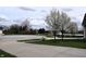 Street view of a manicured lawn and blossoming trees. The sky is lightly overcast at 1630 Valdarno Dr, Greenwood, IN 46143