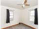 Inviting bedroom with gray vinyl floors, neutral walls and two sunny windows at 1700 N Tibbs Ave, Indianapolis, IN 46222