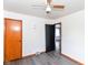 A bedroom with grey vinyl floors and neutral walls shows a standard closet door at 1700 N Tibbs Ave, Indianapolis, IN 46222