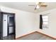 Bright bedroom features gray floors, neutral walls, and a sunny window at 1700 N Tibbs Ave, Indianapolis, IN 46222
