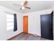 This bedroom features a ceiling fan and a sunny window for ample natural light at 1700 N Tibbs Ave, Indianapolis, IN 46222