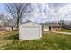 View of detached garage and driveway of home with lawn at 1700 N Tibbs Ave, Indianapolis, IN 46222