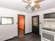 Functional kitchen featuring white appliances, bright cabinets, and dark wood flooring at 1700 N Tibbs Ave, Indianapolis, IN 46222