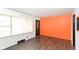 Bright living room features wood-look floors, a large window, and freshly painted walls at 1700 N Tibbs Ave, Indianapolis, IN 46222